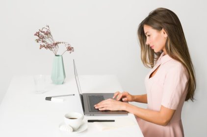 woman-in-pink-dress-using-laptop-computer-1586973